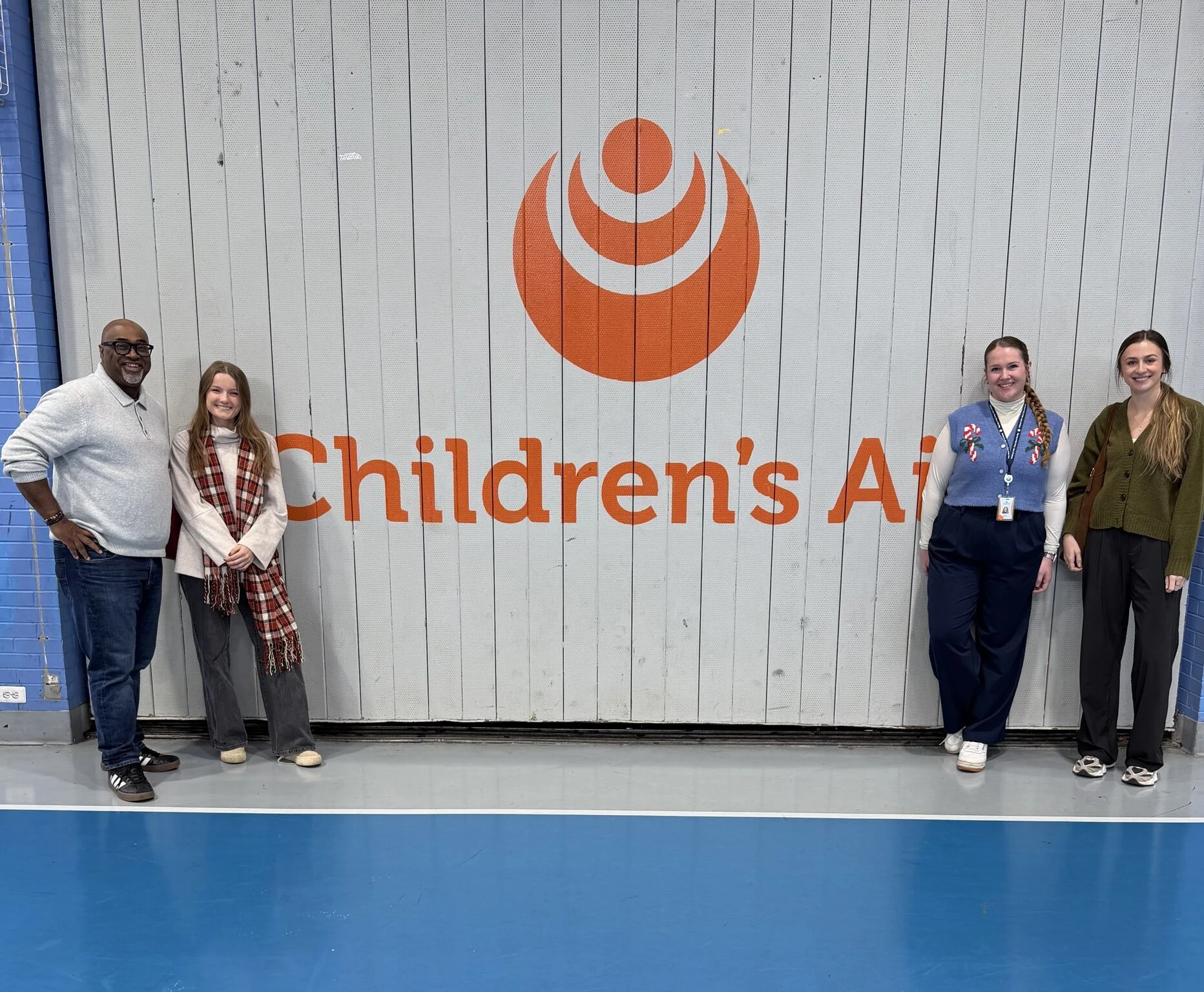 ETC team members grouped together in front with members of the Children's Aid Foundation