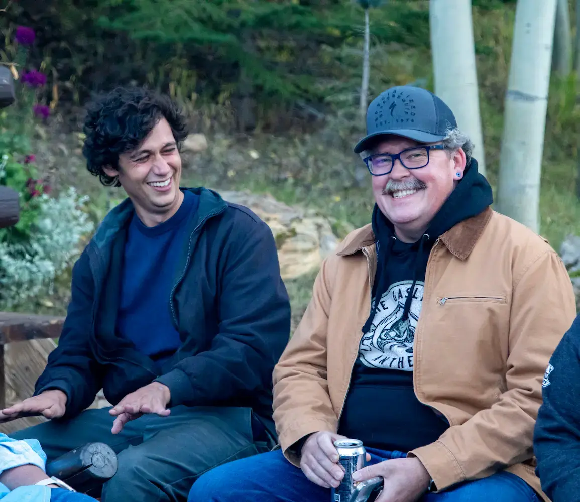 Two ETC members sitting outside sharing a candid moment of laughter