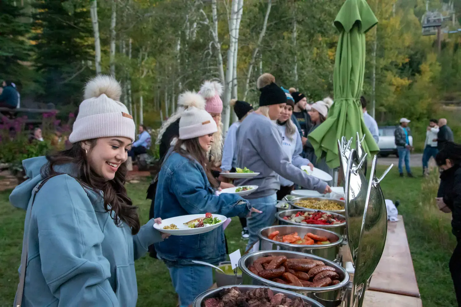 Several ETC team members in a buffet line in the outdoors