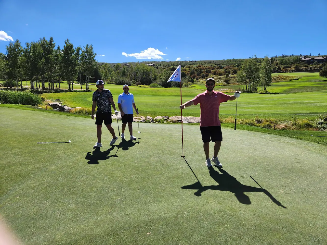 Three ETC Team members playing gold on a putting green