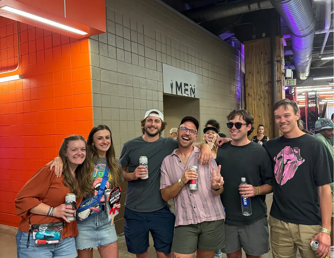 ETC Team members posing for a photo in the concourse at Empower Field