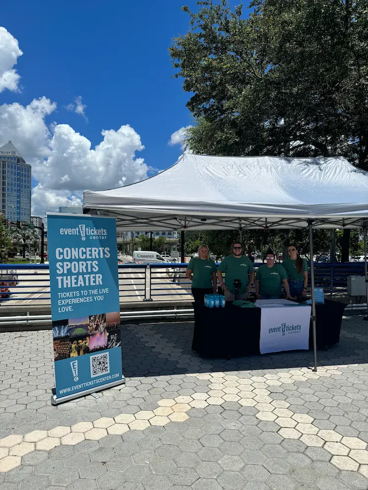 ETC Employees volunteering at a ticket booth