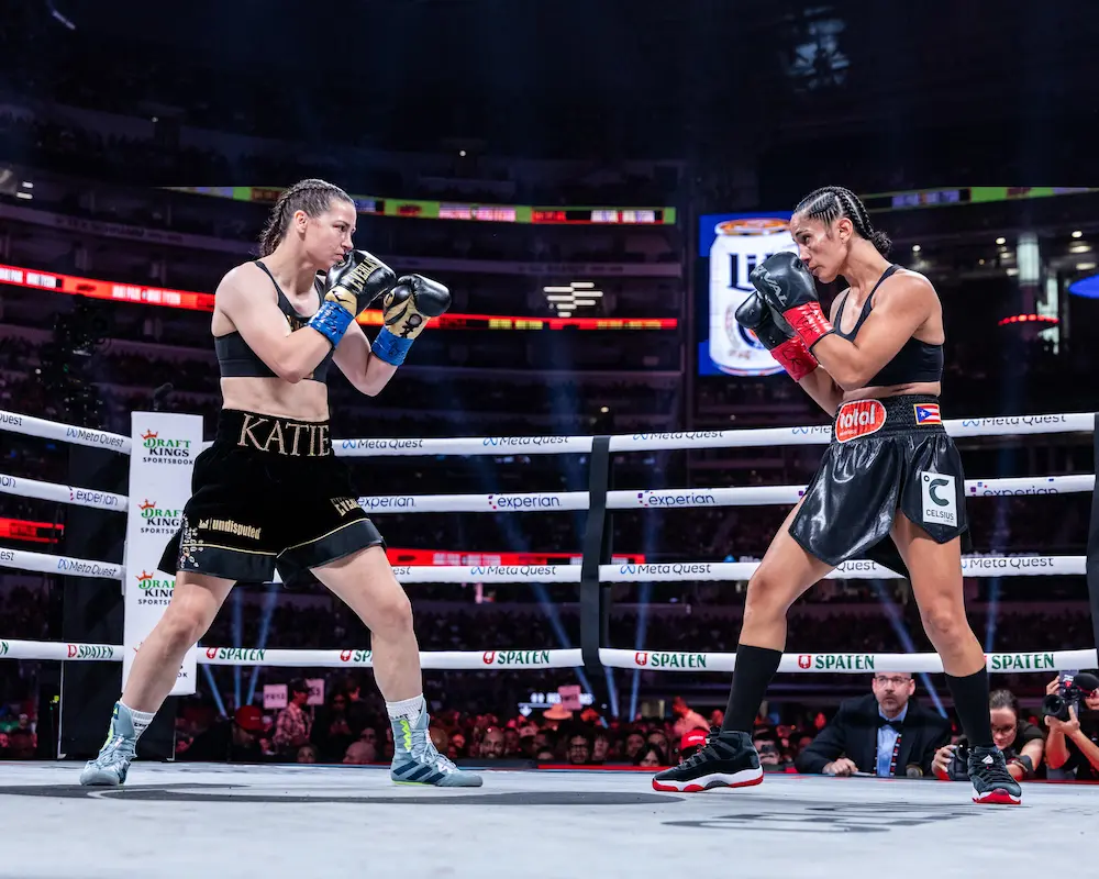Katie Taylor and Amanda Serrano squaring up in the ring as they face off in a boxing match